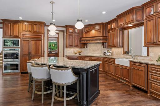 This spacious kitchen is a chef's dream with an abundance of countertop space and plenty of rich American cherry cabinetry with under cabinet lighting