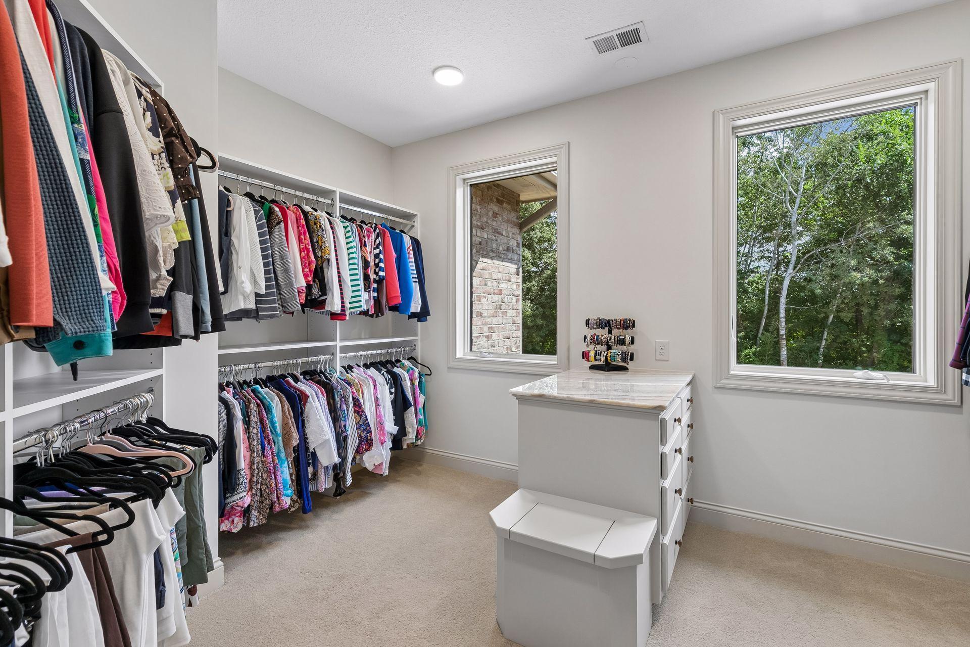 Her dressing room with a quartz top cabinet and built-in drawers. Windows to help provide natural light
