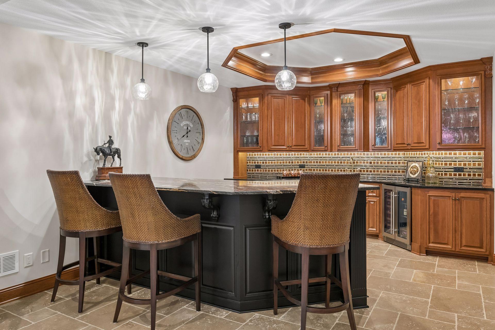 Exquisite wet bar with stainless steel dishwasher and glass door refrigerator