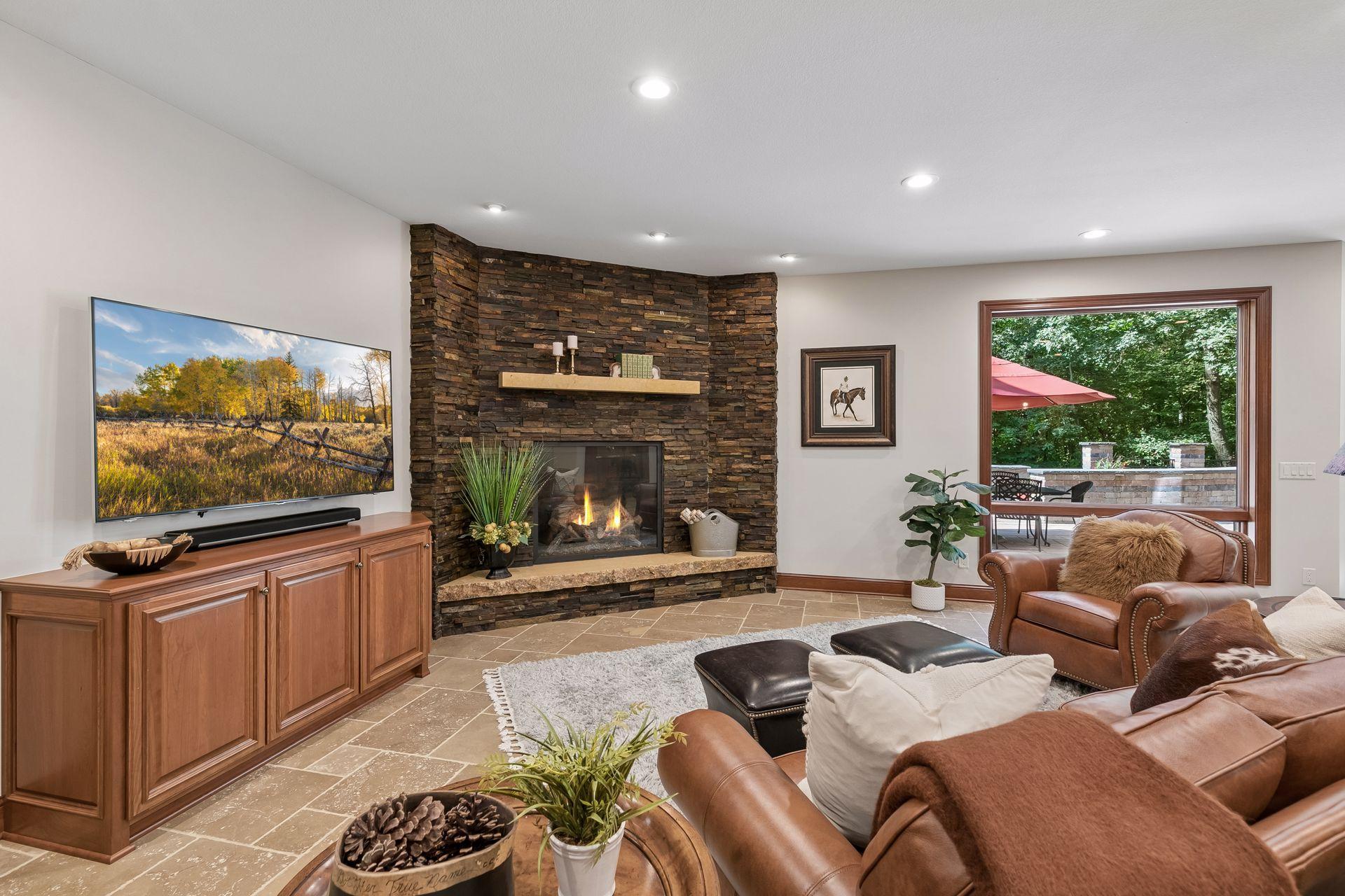 Cozy stone gas fireplace with hearth