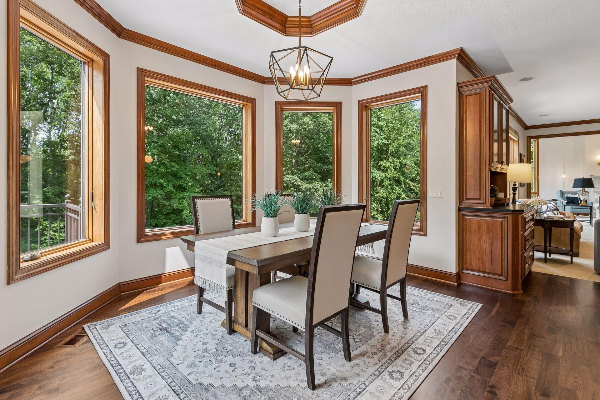 Informal dining room is adjacent to the kitchen and overlooks the treed backyard