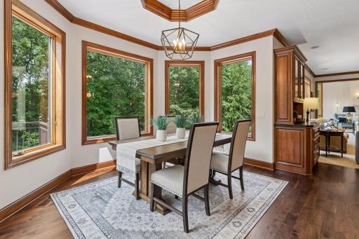 Informal dining room is adjacent to the kitchen and overlooks the treed backyard