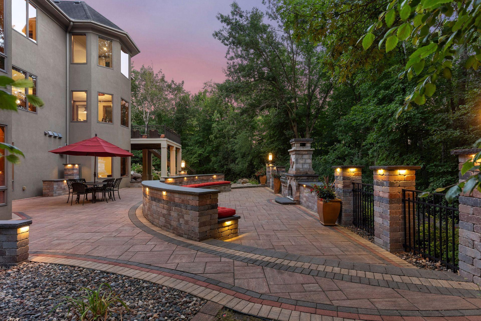 Expansive outdoor living area featuring architectural landscape lighting