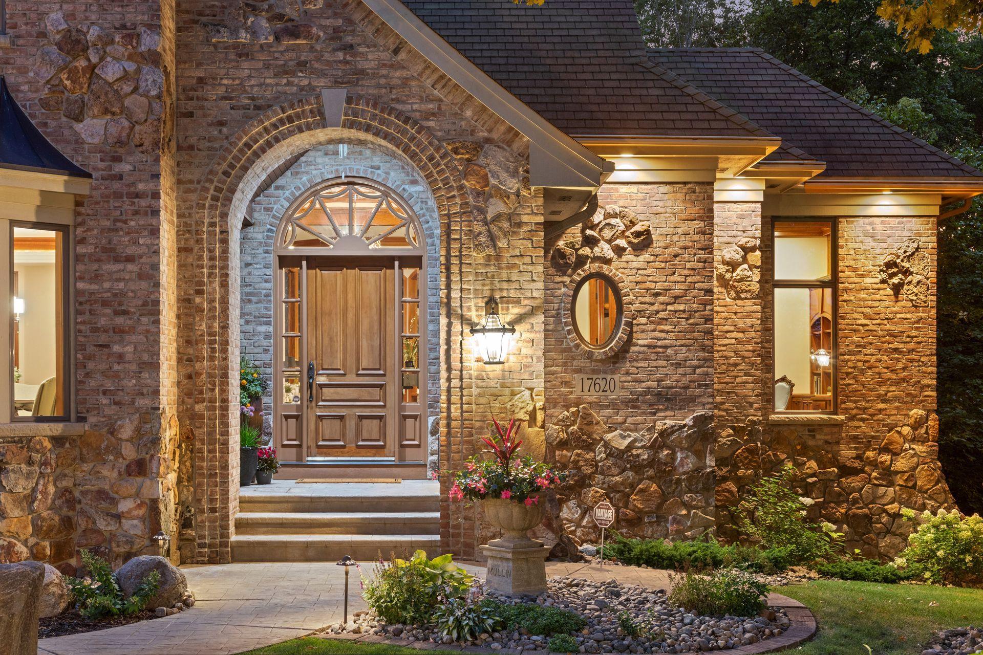 Striking Arkansas River Rock and hand formed brick facade