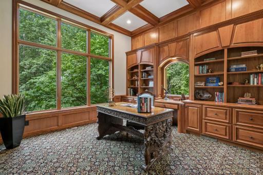 Main floor office with custom built-ins and paneled wood walls
