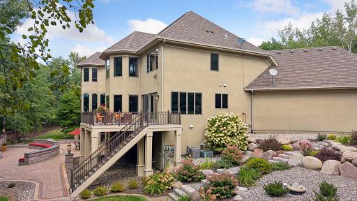 Expansive outdoor entertaining space with large stone patio and Ipe deck that connects to the main floor