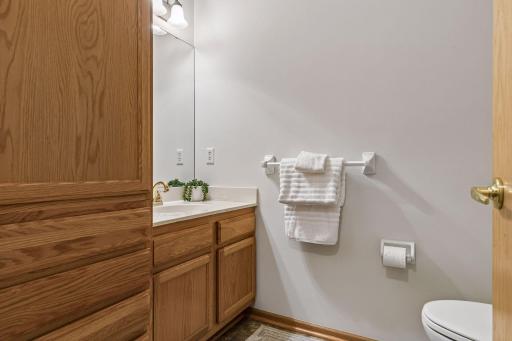Main level large half bath with linen closet storage.