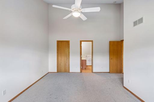 Another view of primary bedroom with vault ceiling. Brand new carpet and fresh paint.