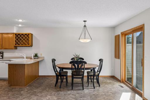 Bright dining area opens to the kitchen and features a breakfast bar plus convenient access to the patio.