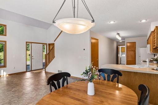 Open dining area with breakfast bar and easy flow to the kitchen, living room and entry.