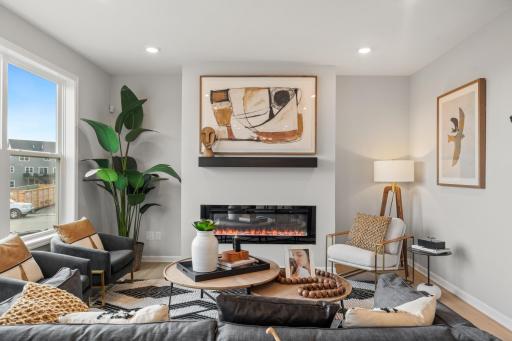 Family Room - photo represents similar floorplan but not identical. Staged model in another community. Finishes and selections may vary. See listing realtors for details.