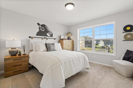 Bedroom 2 - photo represents similar floorplan but not identical. Staged model in another community. Finishes and selections may vary. See listing realtors for details.