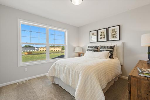 Bedroom 3 - photo represents similar floorplan but not identical. Staged model in another community. Finishes and selections may vary. See listing realtors for details.