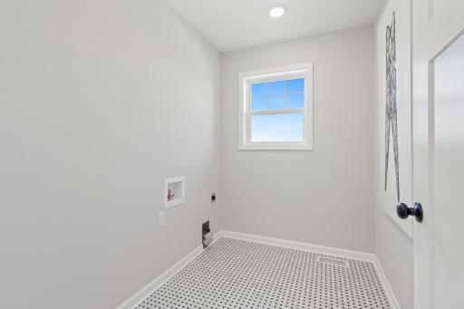 Upstairs laundry room - photo represents similar floorplan but not identical. Staged model in another community. Finishes and selections may vary. See listing realtors for details.