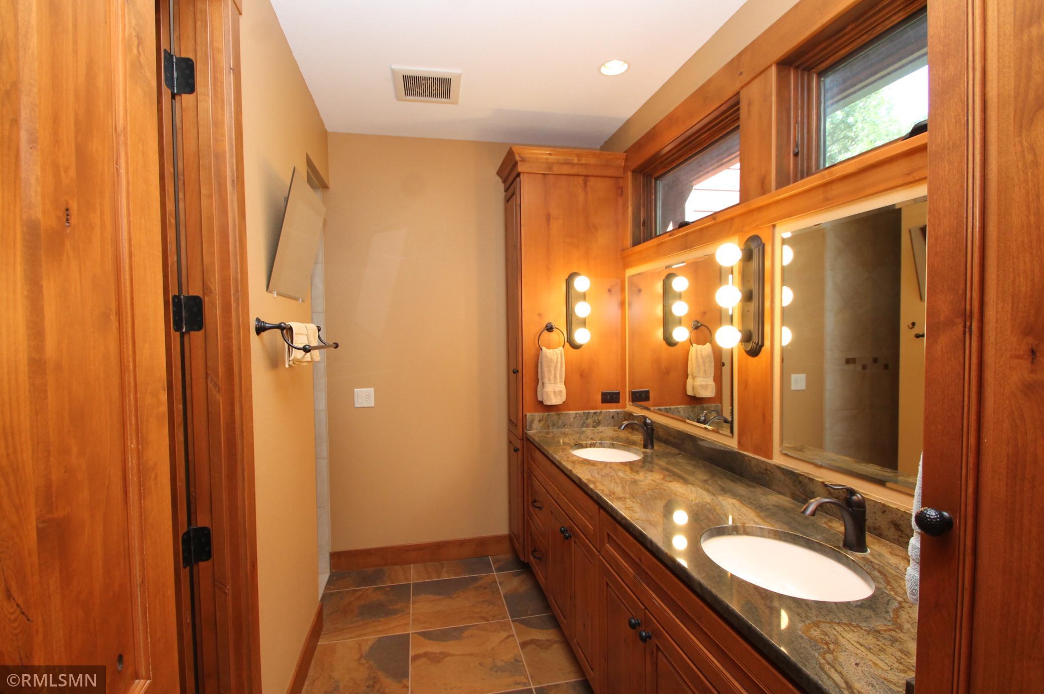 Primary bathroom with double sinks and walk in shower.