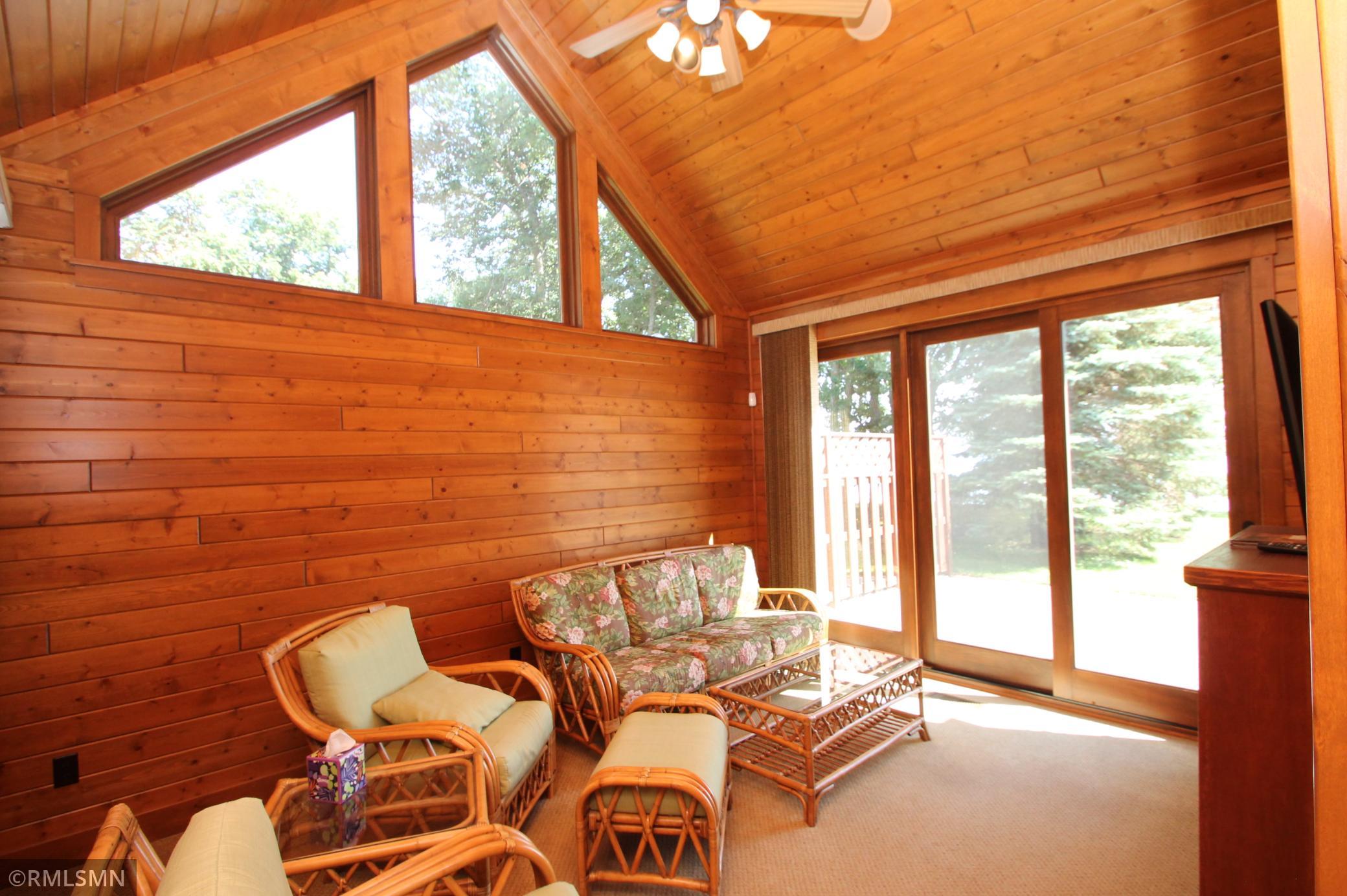 Den/Sun room with vaulted ceilings and doors to patio.