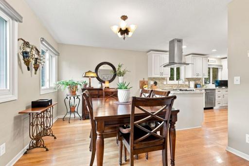 Open-concept living and dining spaces with hardwood floors