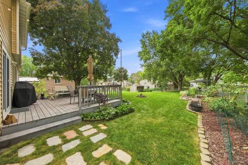 Large, level backyard with mature trees and plenty of green space