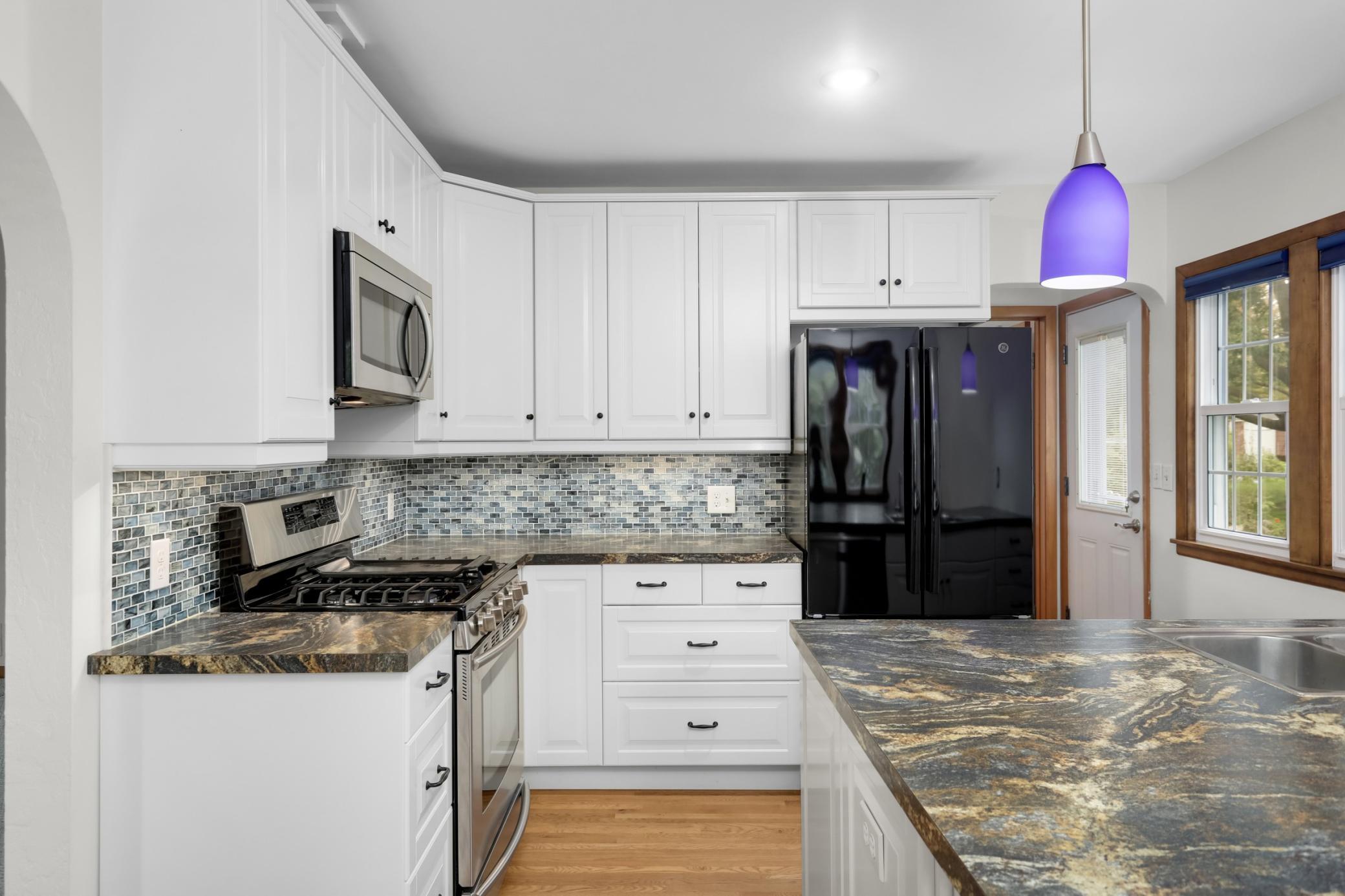 A gas stove and newer refrigerator make meal prep fun, and lends the kitchen a bit of a high-end feel.