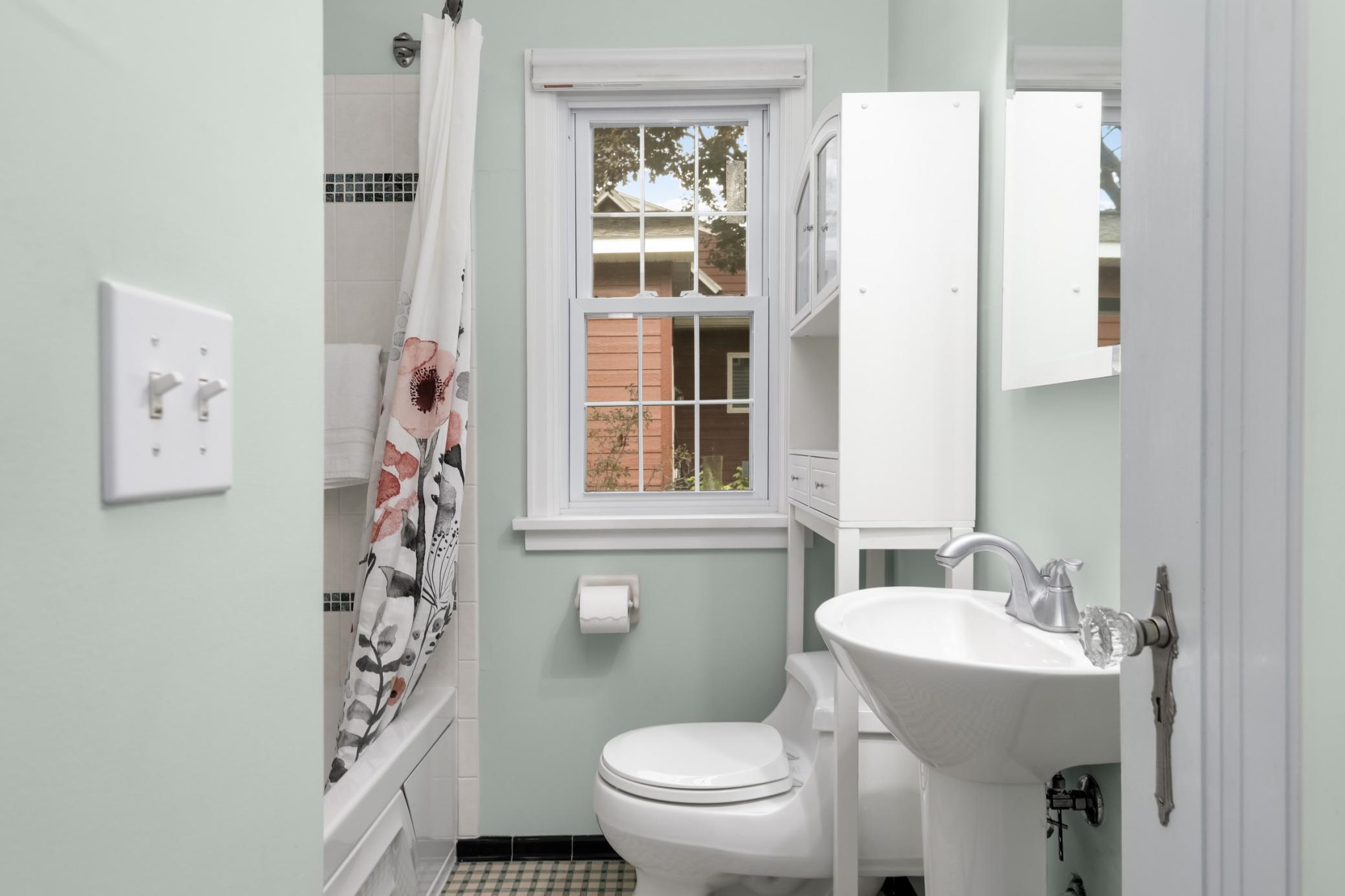 The serene main floor full bath is updated, yet has its original vintage tile floor, in excellent condition.