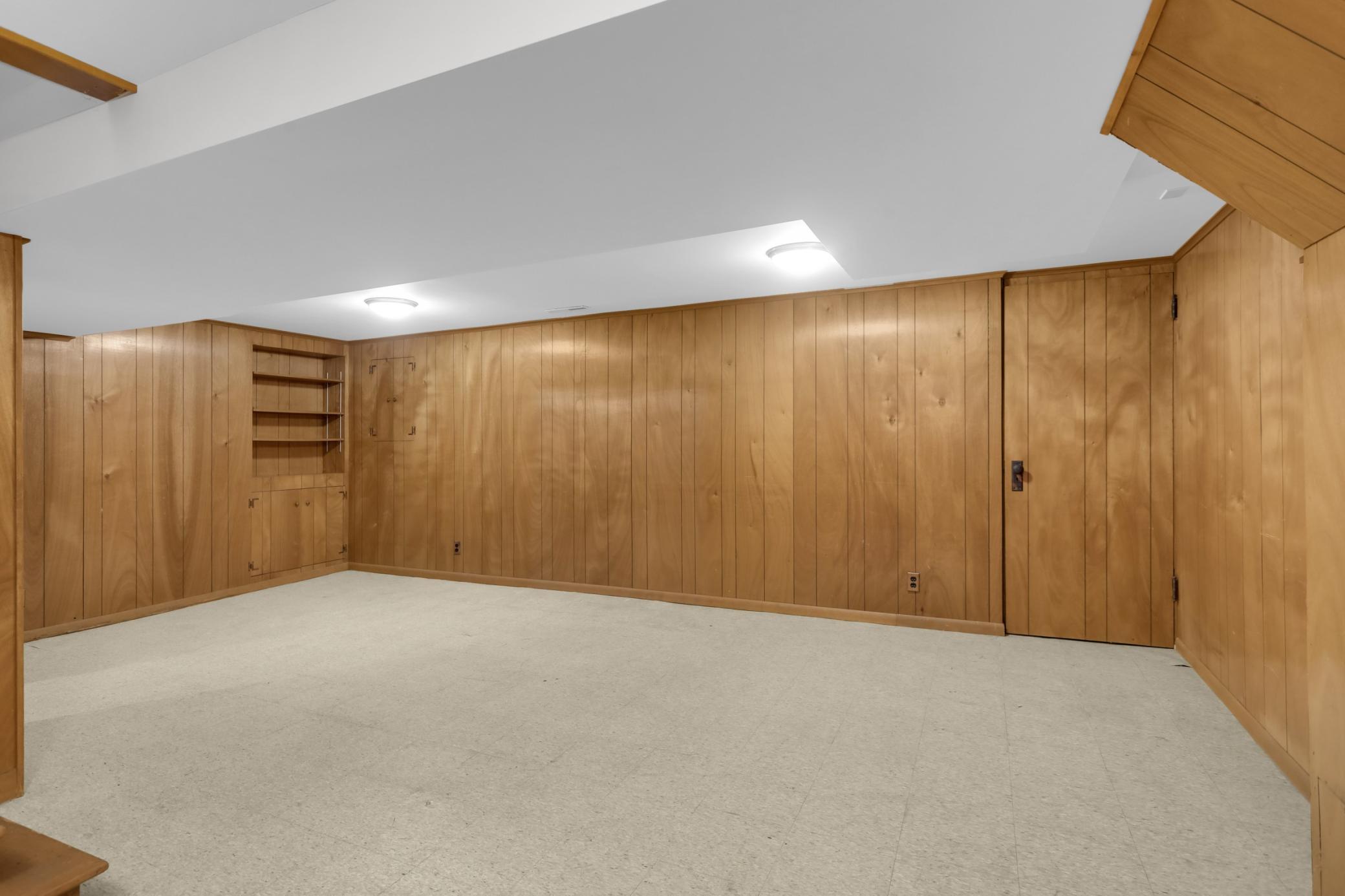 A large open family room on the lower level has a retro vibe that can be enjoyed as is, or you can build equity with a makeover.