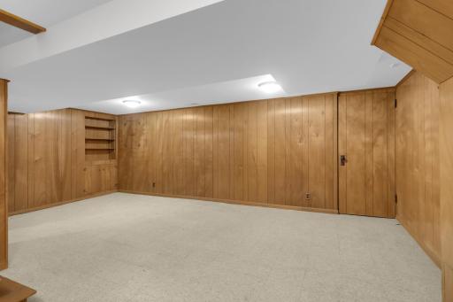 A large open family room on the lower level has a retro vibe that can be enjoyed as is, or you can build equity with a makeover.