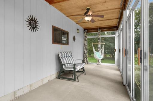 Inside the sunroom / porch--at 16x8, it's big enough for lots more furniture, including a bed. The former owners enjoyed sleeping in the porch on warm summer nights!