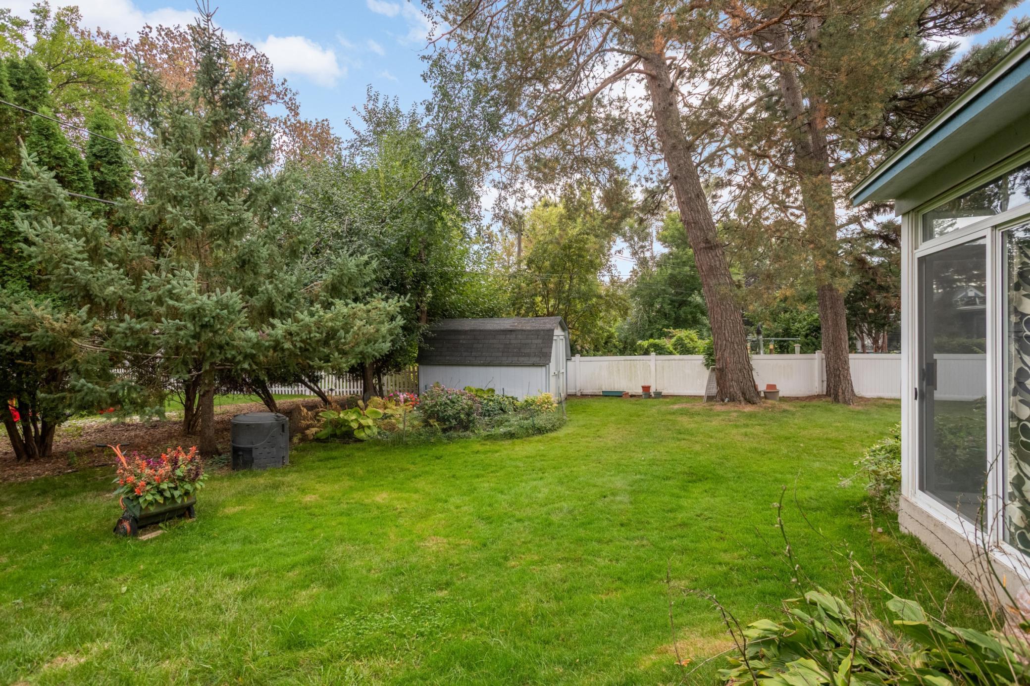 A small storage shed at the back of the lot is a handy place for the lawn mower and garden tools.