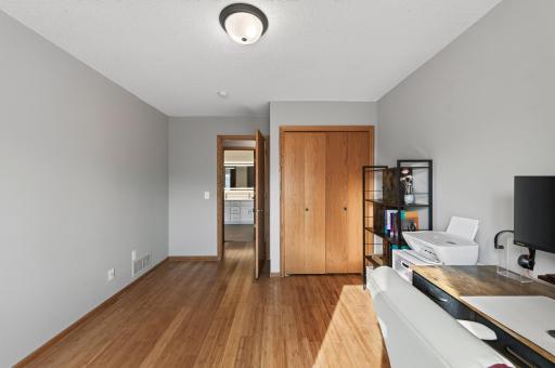 Bamboo flooring continues into the additional bedroom, creating a cohesive look throughout the upper level.