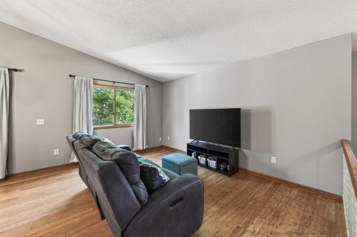 Durable bamboo flooring flow throughout the living room, informal dining area and into each upper level bedroom.
