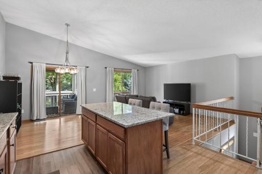 A large center island anchors the kitchen while the open layout creates an easy connection to the dining and living room.