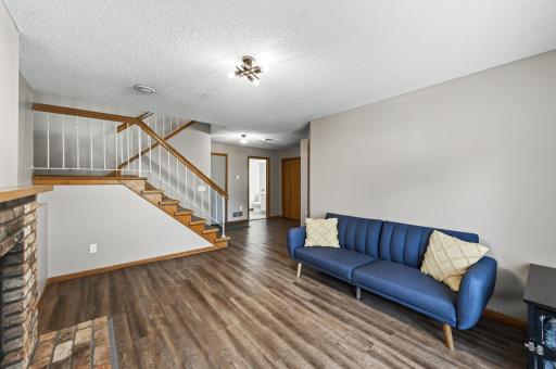 Fresh paint and LVP flooring give this roomy lower-level a refreshed feel, with convenient access to the outdoors.