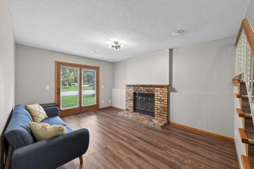 The walk-out lower level is centered around a wood-burning fireplace with classic brick surround.