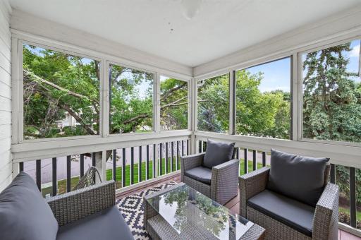 Transition onto the screened three-season porch, an ideal spot for morning coffee, reading or simply unwinding in the fresh air.
