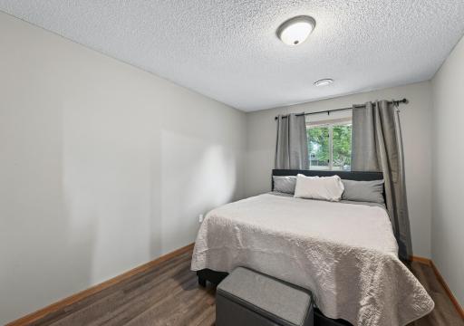 The third bedroom provides comfortable additional living space on the lower level, ideal for guests or a more private retreat.