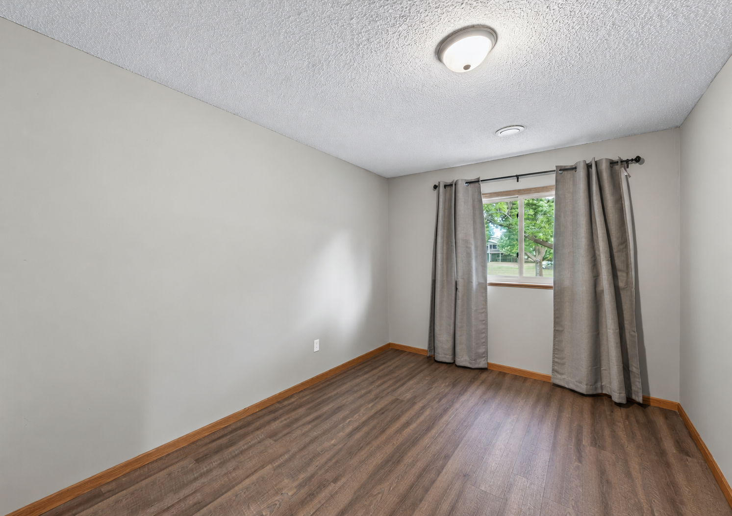 The third bedroom provides comfortable additional living space on the lower level, ideal for guests or a more private retreat.