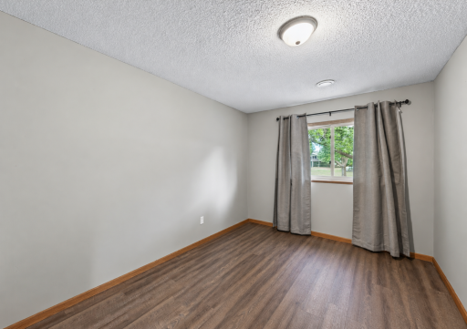 The third bedroom provides comfortable additional living space on the lower level, ideal for guests or a more private retreat.