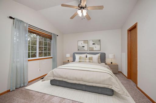 Primary suite offers vaulted ceilings, a ceiling fan, a large walk-in closet, a linen closet, and a walk-through full bathroom!