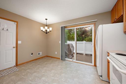 Eat-in Dining space area and a sliding glass door leading to your private patio with mature trees!