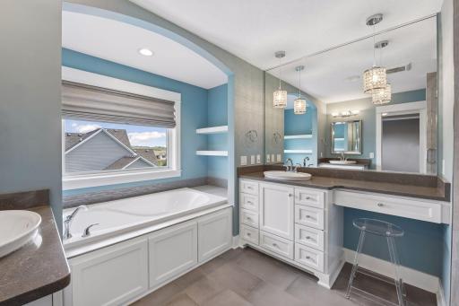 Owner's Pride, primary bath features a soaking tub with whirlpool, double vanity, in floor heat to keep your feet warm on cold winter days