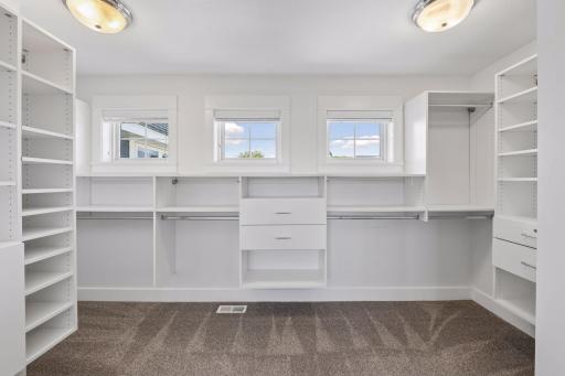 Master Bedroom huge walk-in closet with drawers, shelves, windows.