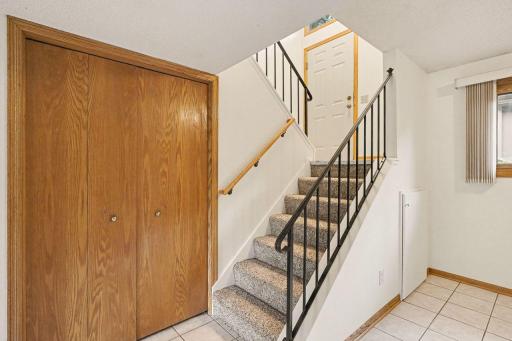 Coat closet just at the base of the stairs