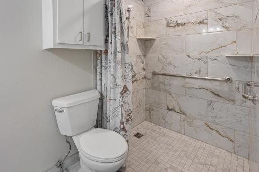 Main bath in the upper level is full tile surround. .