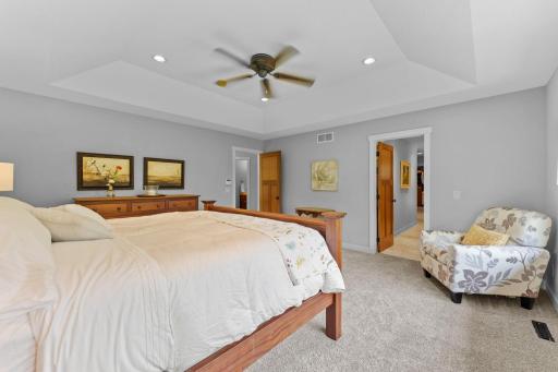 A different view of the primary bedroom, showcasing the entrance to the private en-suite full bathroom.