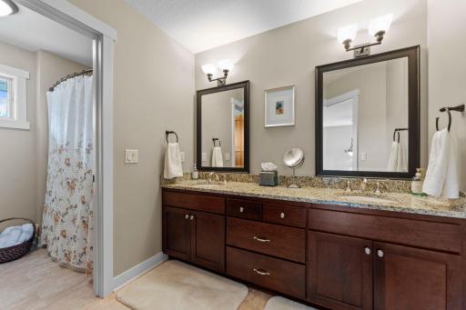 All bedrooms are conveniently located near a shared full bathroom with dual vanities and a separate water closet featuring a large tub and shower combination.