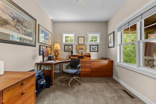 Just off the entryway, the dedicated main-level office features carpeting, pocket doors, and a large front-facing window, creating an ideal work-from-home space.