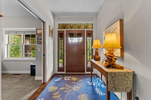 As you enter the home, you are welcomed by warm wood flooring that extends throughout the open-concept floor plan and many of the main-level living spaces.