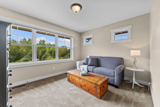 Bedroom two offers comfortable living with carpeting, a large window for natural light, and ample closet space.