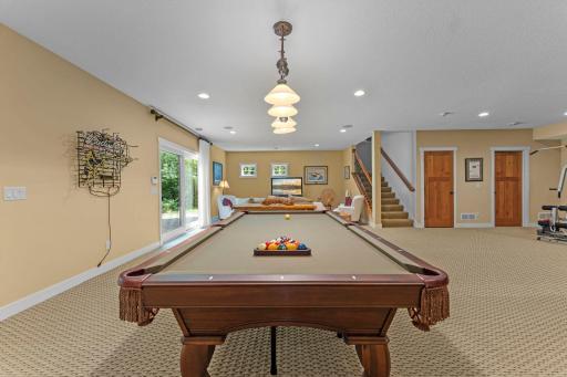 The recreation space offers plenty of room to entertain, complete with a pool table for hours of fun.