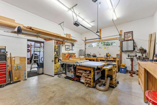 The fourth stall is thoughtfully separated from the other three and offers the perfect workshop space, featuring its own sink, heater, and stall door with convenient side-of-home access.